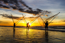 Fishermen Fishing In The Sea At Sunrise
