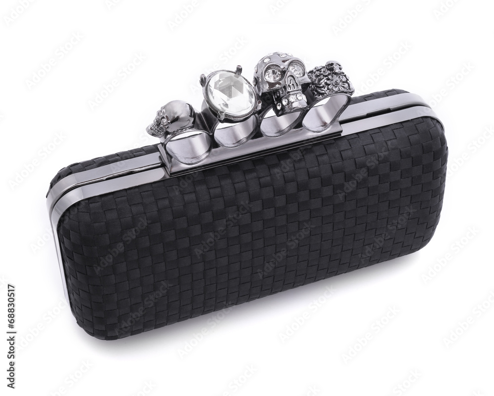 Black handbag brass knuckles and a skull on a white background
