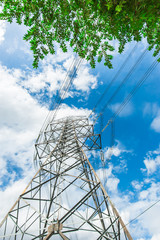 High voltage pole with trees