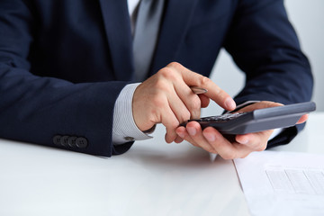 Men's hands with calculator