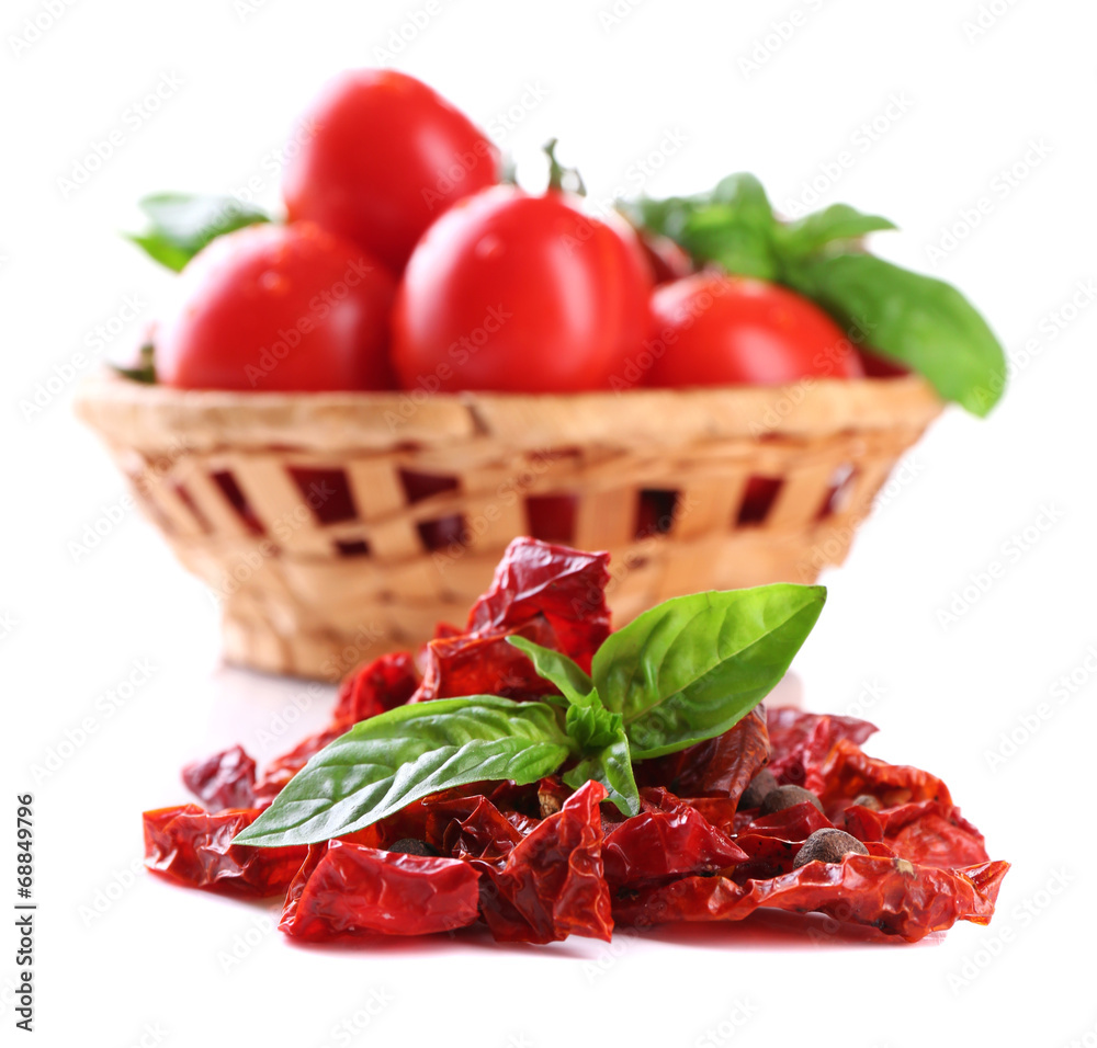 Sun dried tomatoes, fresh tomatoes in wicker basket,  basil