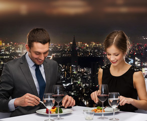 Poster - smiling couple eating main course at restaurant