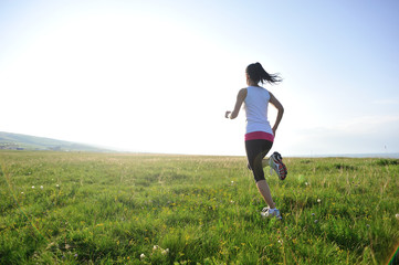 Poster - Runner athlete legs running on  grass seaside