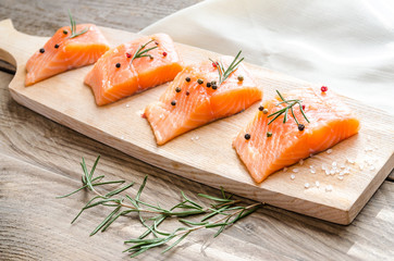 Wall Mural - Raw salmon steaks on the wooden board