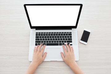 Female hands typing on a laptop keyboard