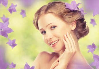 Wall Mural - Beauty face of beautiful girl with purple and lilac flowers