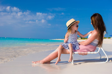 Sticker - Young mother and adorable little daughter at tropical beach