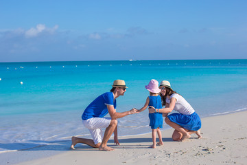 Wall Mural - Happy family enjoying beach vacation