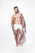 Male muscled underwear model wearing white shorts. Blonde hair.