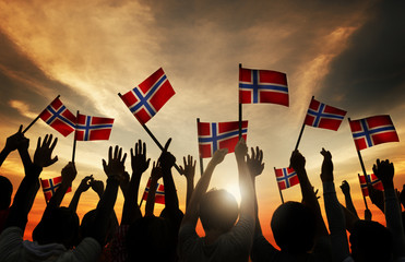 Sticker - Group of People Waving Norwegian Flags in Back Lit