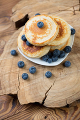 Wall Mural - Homemade fritters with blueberries over rustic wooden surface