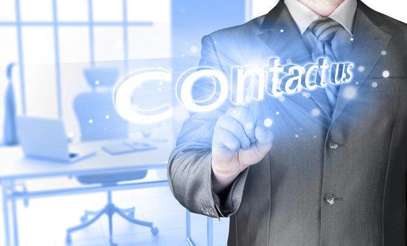 Businessman pushing CONTACT US sign
