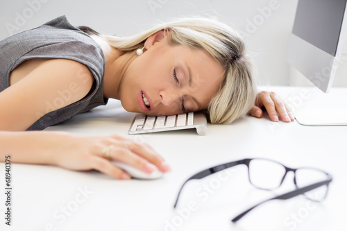 Fotografie, Obraz Exhausted woman sleeping in front of computer