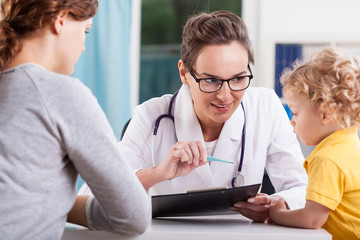 Wall Mural - Mother with baby during medical appointment