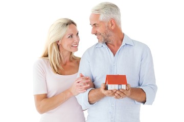 Poster - Happy couple holding miniature model house