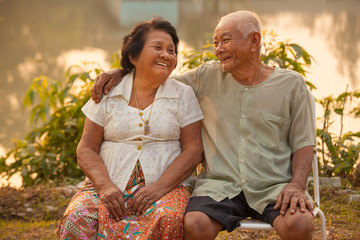 Happy Senior couple sitting outdoors