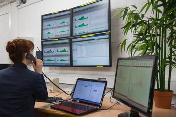Poster - Technician sitting in office running diagnostics