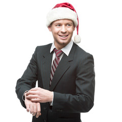 Canvas Print - young smiling businessman in santa hat pointing at watch