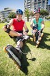 © WavebreakmediaMicro - Fit mature couple tying up their roller blades on the grass