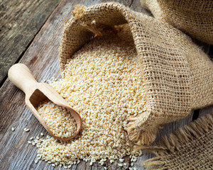 sesame seeds in sack on  rustic table