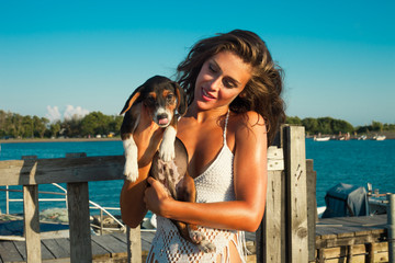 puppy and girl at seaside