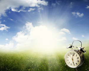 Poster - Alarm clock in field. Springtime. Daylight savings