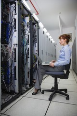 Aufkleber - Technician sitting on swivel chair using laptop