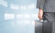 © WavebreakMediaMicro - Composite image of businessman holding briefcase