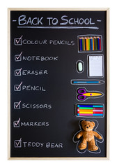 School supplies over blackboard background