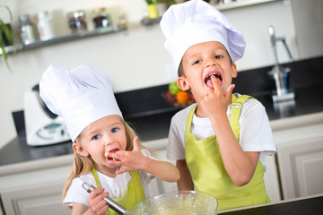 Wall Mural - happy childrens kids family preparing funny cake kitchen at home