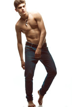 Male Beauty & Blue Jeans Concept. Handsome Male Model In Jeans