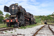 Ancient Train With A Steam Locomotive On Rails