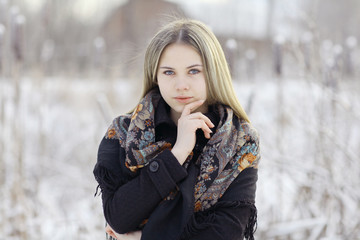 Wall Mural - Beautiful Russian woman in a scarf in winter