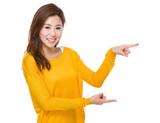 Young woman with two finger point aside