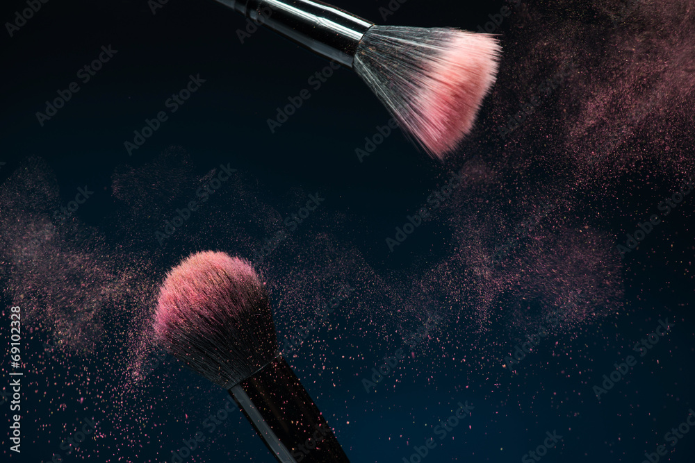 Professional black make-up brush with pink powder in motion isol - obrazy, fototapety, plakaty 