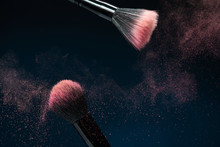 Professional Black Make-up Brush With Pink Powder In Motion Isol