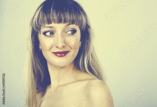 Poster beautiful woman with long hair and blue eyes in the studio