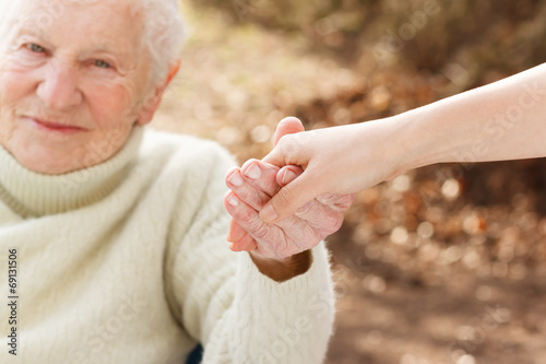 Fotografie, Obraz Senior woman holding hands with young lady