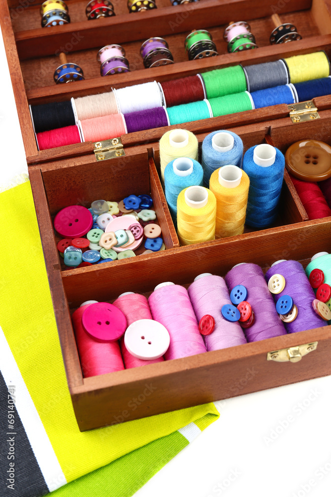Colorful threads for needlework in wooden box close up