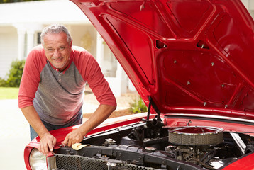 Retired Senior Man Working On Restored Classic Car