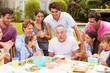 © Monkey Business - Multi Generation Family Celebrating Birthday In Garden
