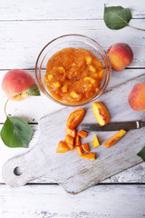 Sticker - tasty peach jam with fresh peaches on wooden table