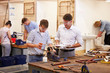 © Monkey Business - Teacher Helping College Students Studying Plumbing