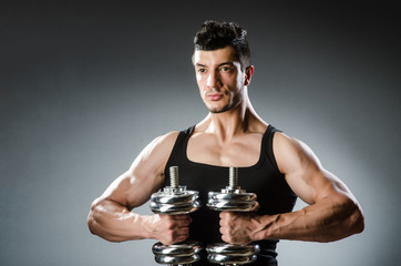 Muscular ripped bodybuilder with dumbbells