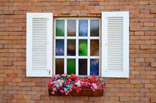White Window On Red Brick Wall And Color Glass Hang Flowers Pot.