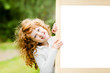 Smiling girl near a white board. Educational and medical concept