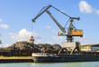 Harbor - crane loading a ship with scrap metal