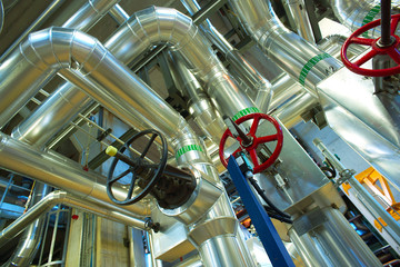 Equipment, cables and piping as found inside of a modern industr