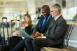 © michaeljung - business travelers using laptop