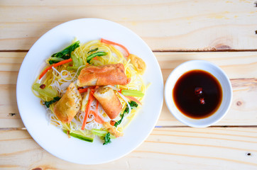 Wall Mural - Vietnamese food. Sauteed noodle with crispy spring rolls